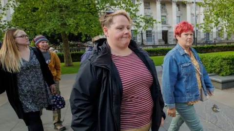 PA Media Sara Canning (second from right), Lyra McKee’s partner outside Laganside Court in Belfas