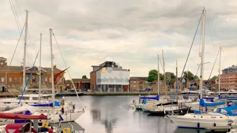 Ipswich Borough Council A view of part of the waterfront showing various boats on the water and buildings in the background.