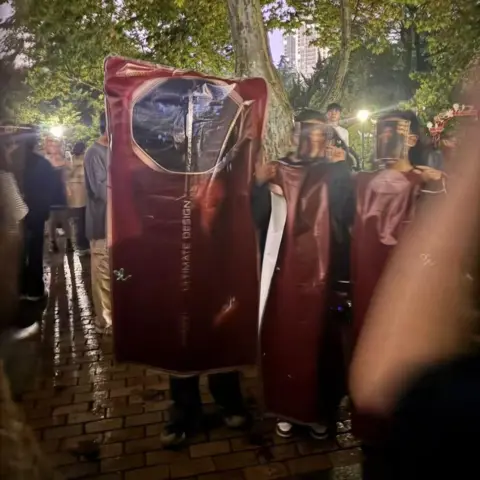 BBC Chinese Halloween revellers dressed as the latest Huawei folding phone