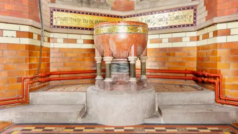 HE Church of St Anne, St Anne's Drive, Haughton, Denton, Greater Manchester.   Interior, detail of restored font and flooring