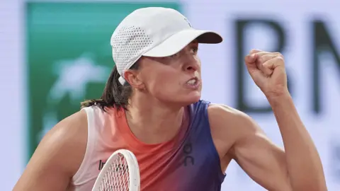 Iga Swiatek clenches her fist at the French Open