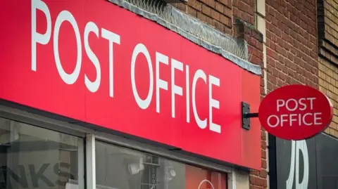 Getty Images A Post Office branch sign on a UK High Street