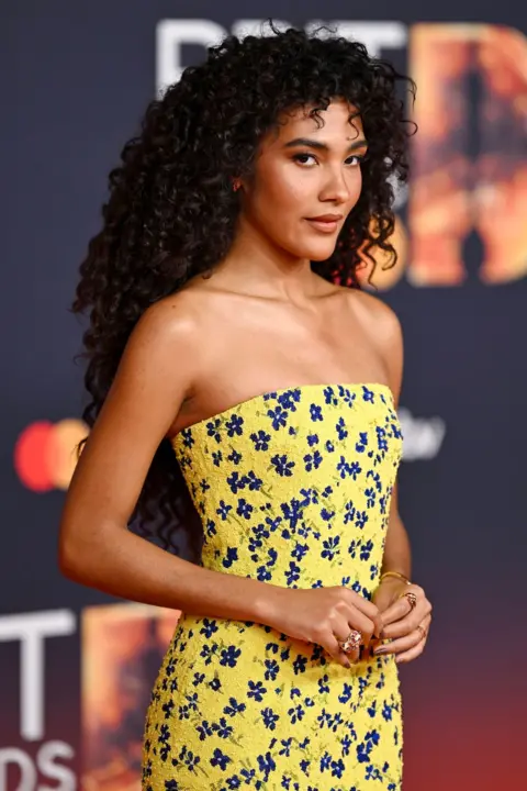 Getty Images Olivia Dean in a yellow dress