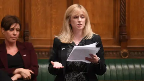 Reuters Rosie Duffield making a speech in the House of Commons, with Labour colleague Jess Philips sitting behind her.