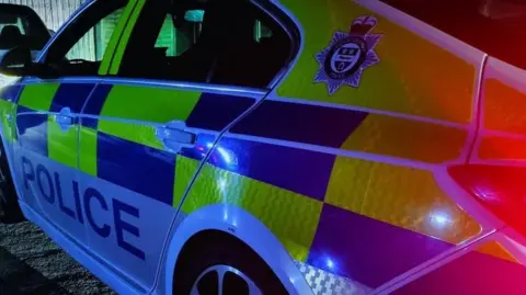 Image of a Leicestershire Police car at night