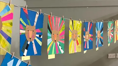 The Lewis Foundation A range of art designs featuring the face of a brown surrounded by a kaleidoscope of different colours.