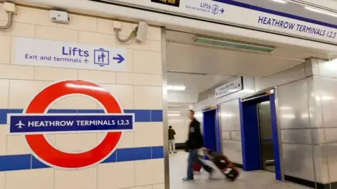 Close-up of the London Underground sign for Tube station Heathrow Terminal 1,2,3