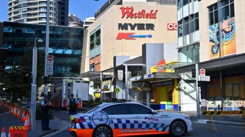EPA A police car parked outside the Westfield Bondi Junction shopping centre
