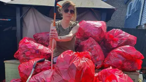 Miriam Whitham Volunteer with bags of litter 