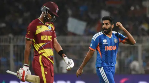 India bowler Jasprit Bumrah (right) celebrates the wicket of West Indies' Roston Chase in a T20 World Cup match earlier in 2026
