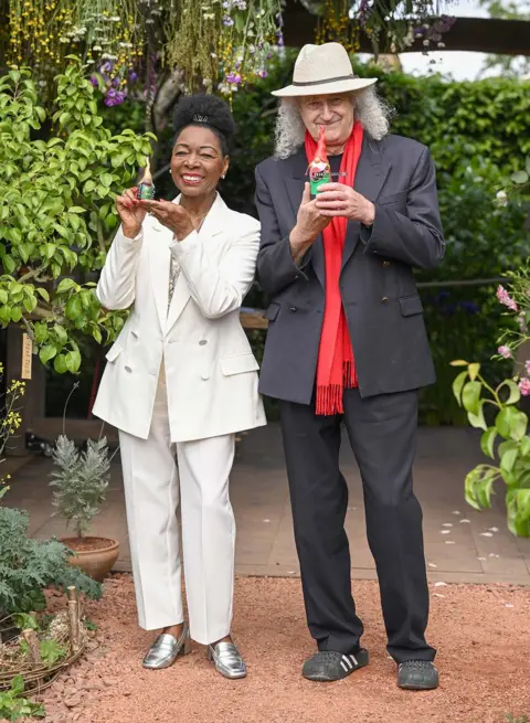 Getty Images Baroness Floella Benjamin and Sir Brian May holding the gnomes they painted to raise money for the RHS Campaign for School Gardening, at the RHS and The King's Foundation Curious Garden exhibit, during press day at the RHS Chelsea Flower Show, 