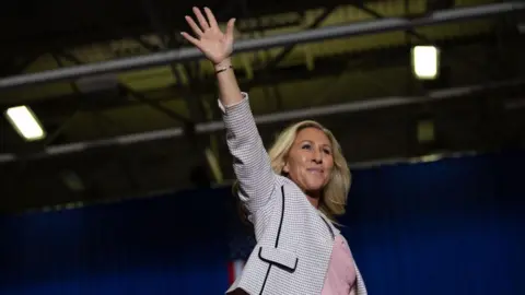 Getty Images File image of Marjorie Taylor Greene waving to supporters at an event in Michigan