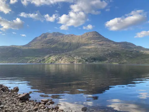 Norman Hunter Loch Maree in the North West Highlands on a warm and sunny day