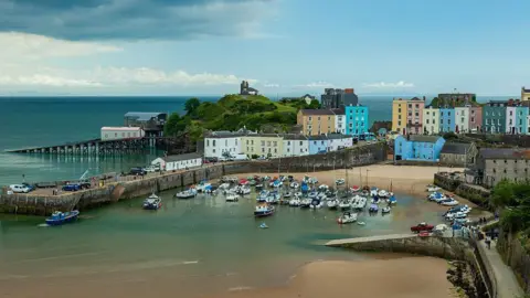 Getty Images A picture of Tenby harbour with different coloured houses situated above it