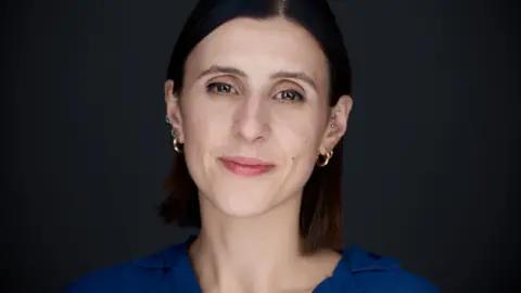 Rosanna Ellul A woman with short brown hair smiles at the camera