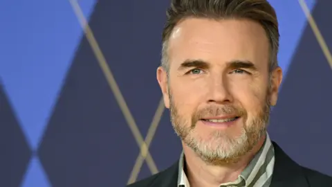 Getty Images Gary Barlow looking towards the camera and smiling.