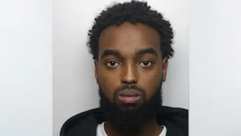 Thames Valley Police A police mugshot of Mohamed Abdulle, who is staring ahead. He has a short moustache and longer black beard and short, curly hair on top of his head. He is showing no emotion.