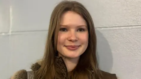 Claire Hamilton/BBC Rachael Murph has long brown hair
