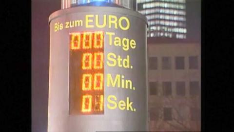 Countdown counter with 1 second remaining on it.  Text says "Bis zum EURO" and then the counter says "000 Tage, 00 Std, 00 Min, 01 Sek."  High rise buildings are in the background.