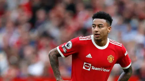 Jesse Lingard when he played for Manchester United, wearing the team's kit with his hands on his hips as they played Norwich City at Old Trafford on 16 April 2022.