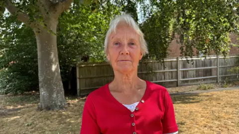 A woman in a red top.