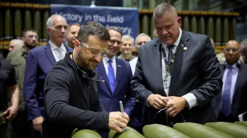 Reuters President Volodymyr Zelensky signs ammunition during his visit to the Scranton Army Ammunition Plant (SCAAP) in Scranton, Pennsylvania, U.S., September 23, 2024