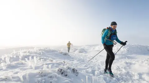 Adam Wild Gossage treks over snow and icy ground during the race. 