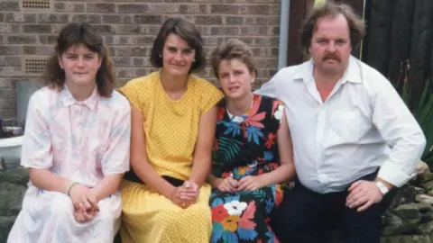 supplied An old family photo from the 1980's with a Mum and Dad and two teenage daughters. They smile for the camera.