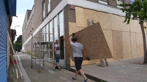 PA Windows being boarded up at Foxtons in North Finchley 