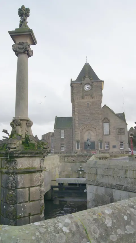 Richard Dorrell A view of the Cornmill Fountain with a church in the background