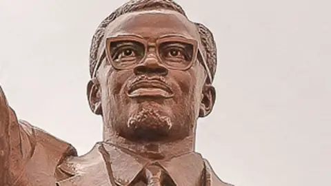 A close-up crop of a statue of Patrice Lumumba