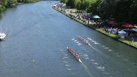 A boat race takes place on the river.