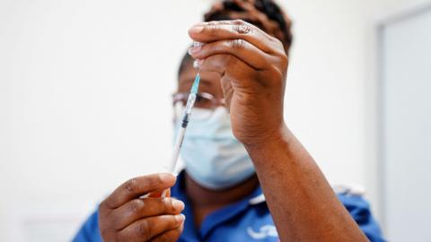 A nurse prepares a dose of a coronavirus disease (COVID-19) vaccine