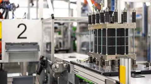 Quest One An electrolyser sits on a production line at Quest One's factory. It's rectangular in shape, about the size of a shopping basket with a metal grid around the outside.