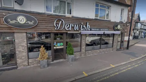 Google A restaurant frontage with the word "Derwish" displayed in large silver letters