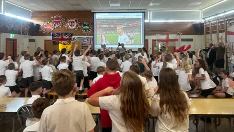 Schoolchildren watching the England match