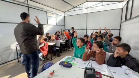 Children study in a school in Gaza