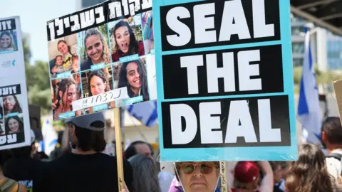 A woman holds up a sign saying "Seal the deal" at a protest calling for a Gaza ceasefire and hostage release deal in Tel Aviv, Israel (2 September 2024)