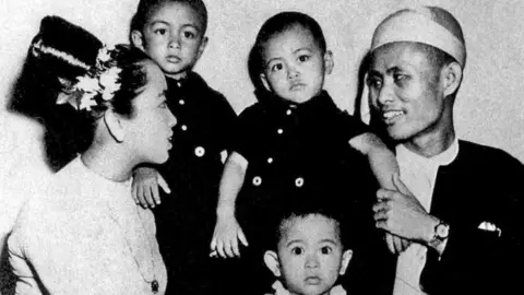 History/Universal Images Group via Getty Images Aung San (right) with his wife Daw Khin Kyi and their three children including Aung San Suu Kyi as a baby, (front centre), Yangon, 1947