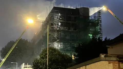 BBC/SIMON JONES Forty fire engines and around 225 firefighters are battling a blaze at a mixed-use residential and commercial building on Freshwater Road in Dagenham.