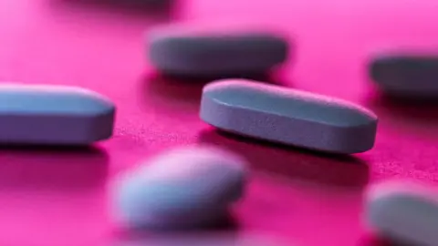 Getty Images image shows proxy pills placed for photos in Mumbai, India against a pink background. 