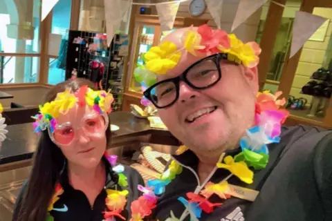 Jody Bunting A selfie taken by Jody Bunting of him with Kimberley Hoskins, both wearing florwer garlands