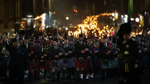 Ian Georgeson Pipers at the front of the torchlight procession in Edinburgh.
