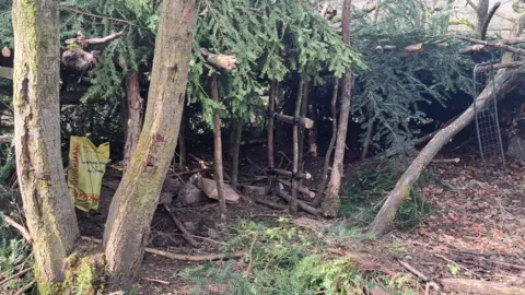 Supplied A wooden den inside Buxton's Grin Low Woods