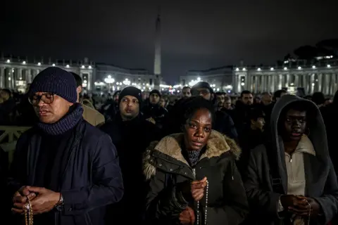 Getty Images People attend Rosary prayers led by Vatican State Secretary Pietro Parolin in St. Peter's Square on February 24, 2025 in Vatican City, Vatican