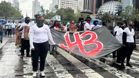 Protesters in Mexico City with a banner commemorating the 43 missing student teachers