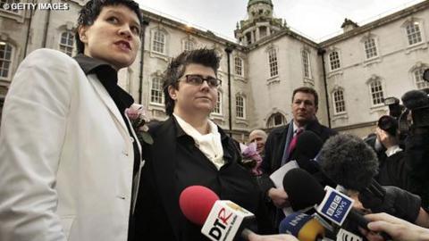Shannon Sickles and Grainne Close address reporters and a multitude of microphones outside Belfast City Hall.