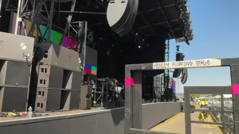 A general view of the front of the stage at the Henley Festival, with a sign that says "Henley Floating Stage" to the right of the picture.