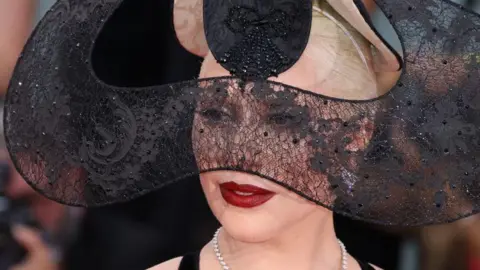 Getty Images Lady Gaga in an elaborate black lace headdress and deep red lipstick