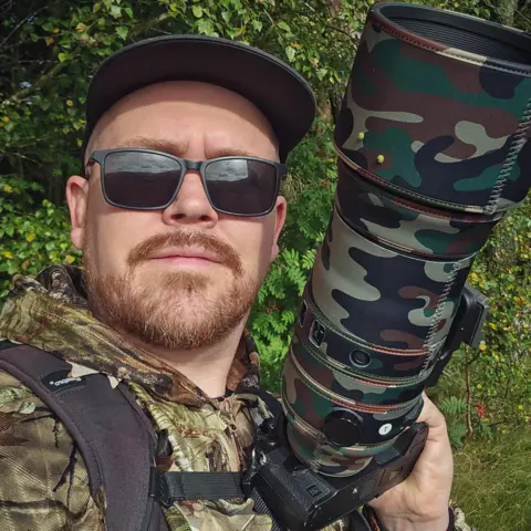 Jimmy Reid Jimmy Reid wears camouflage gear to take pictures of owls